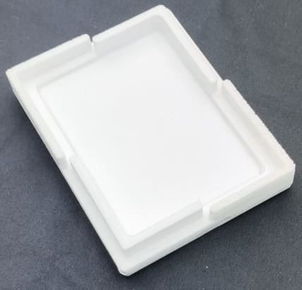 A white plastic tray sitting on top of a table.