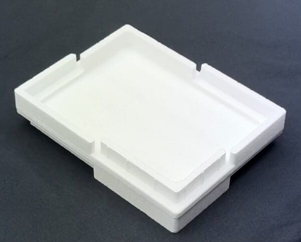 A white plastic tray sitting on top of a table.