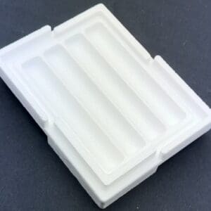 A white tray with several compartments on top of it.