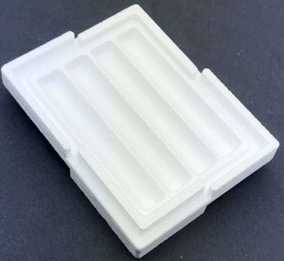 A white tray with several compartments on top of it.