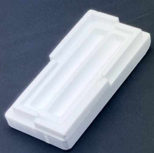 A white plastic container sitting on top of a table.