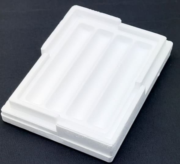 A white plastic container sitting on top of a table.